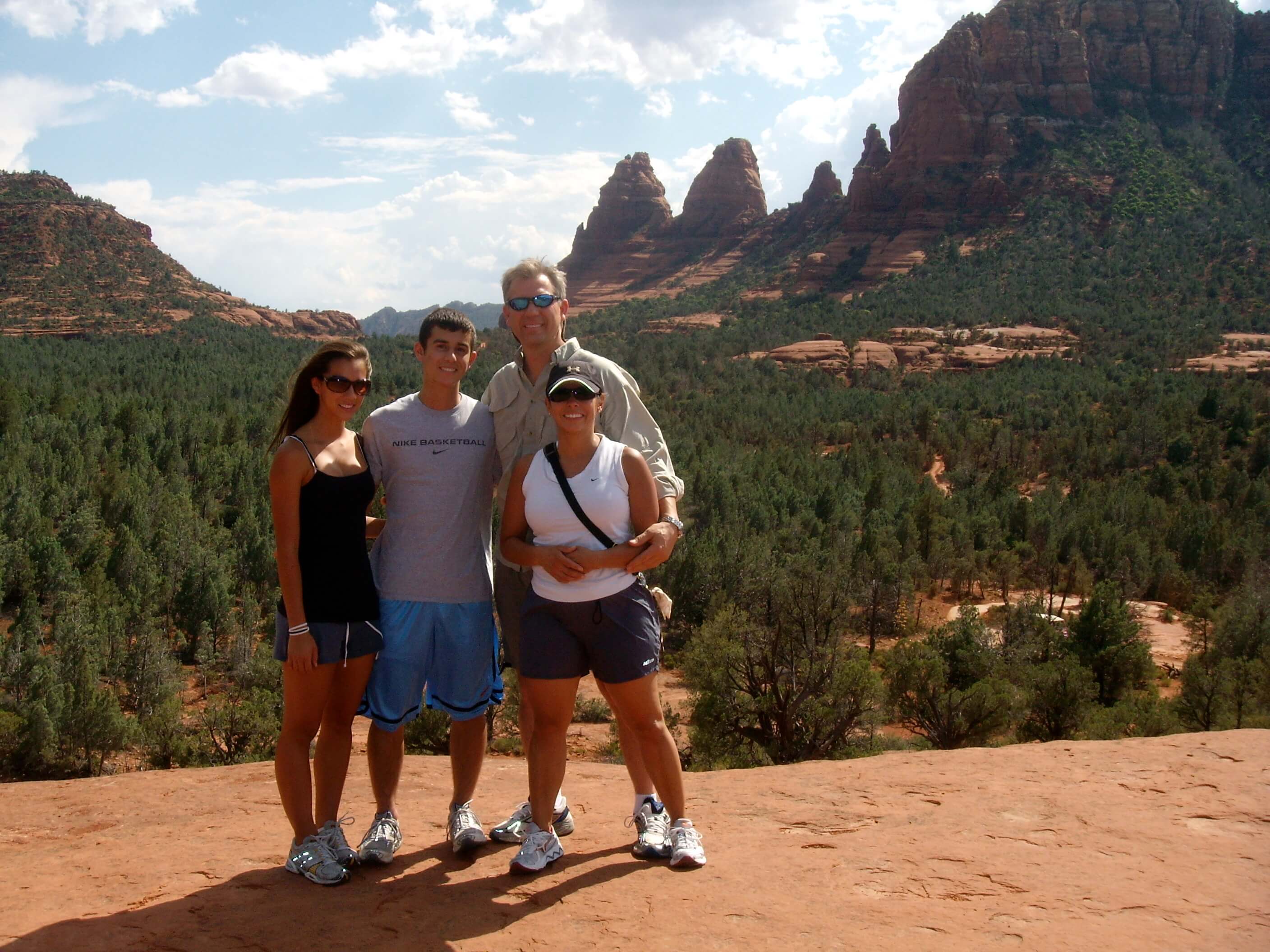 Alex Powell and his family posing for a photo during a vacation together