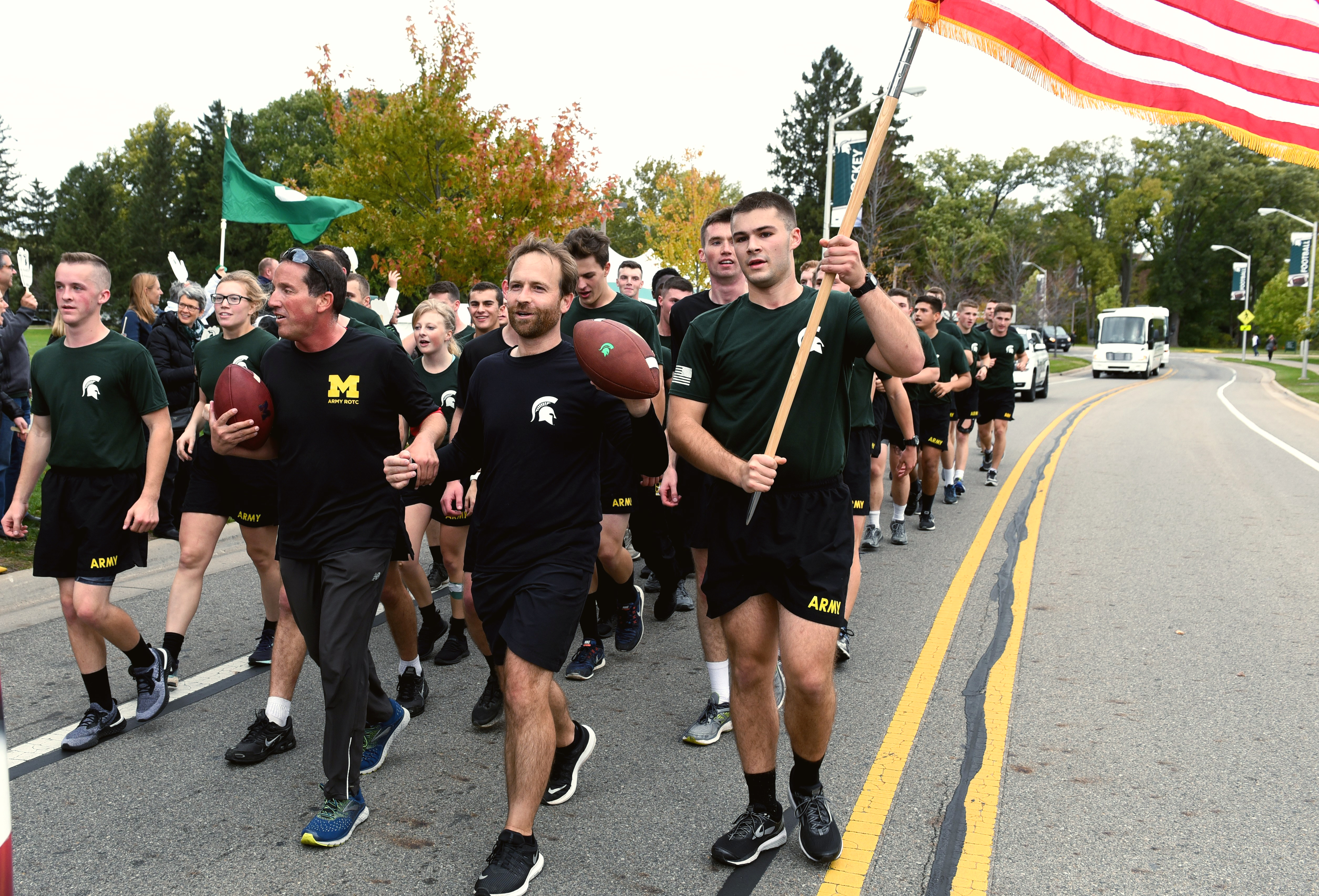 University of Michigan and Michigan State University ROTC members walking Alex's Great State Race