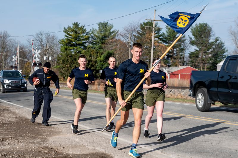 ROTC cadets running with flag