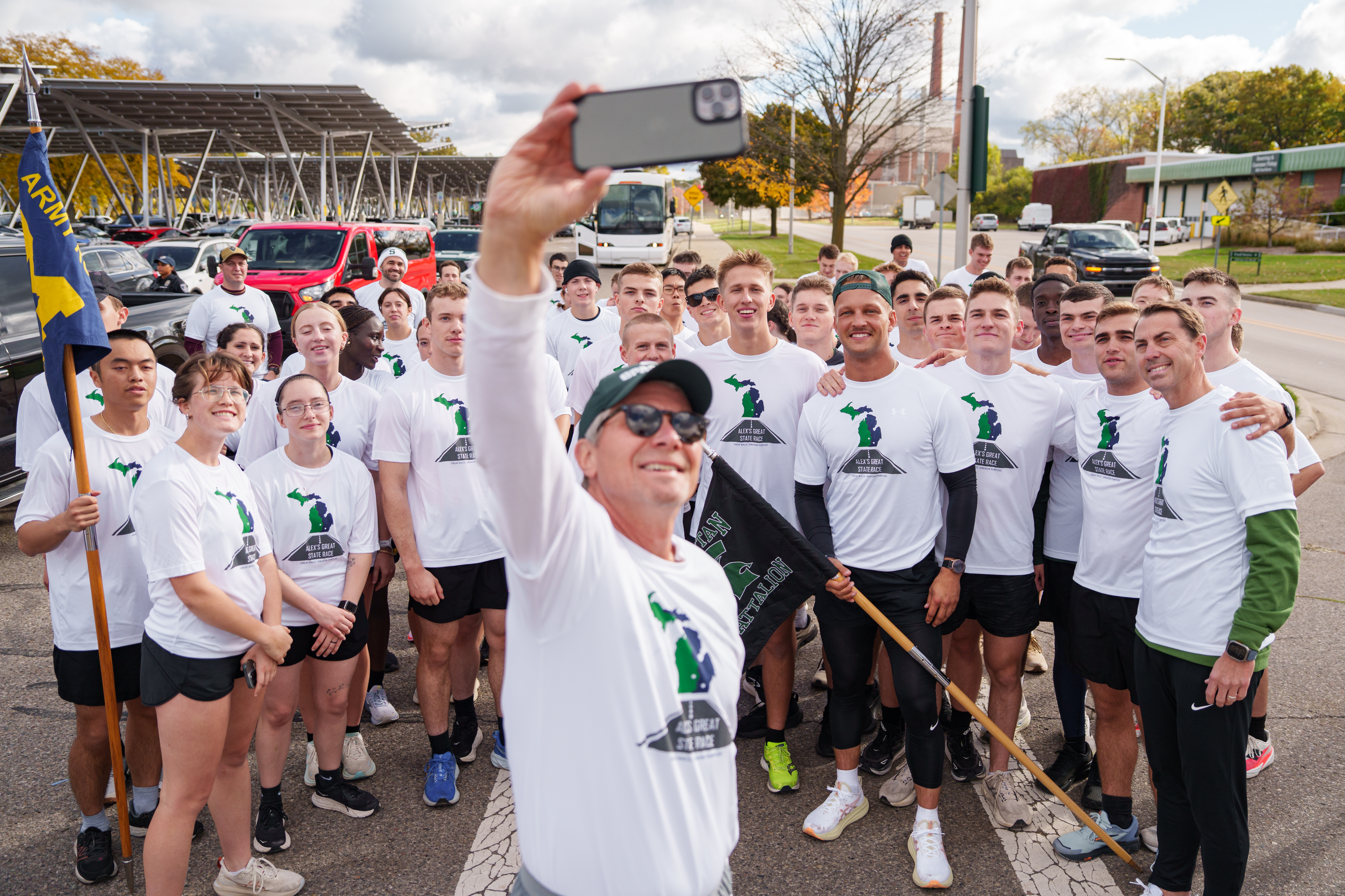 MSU President Guskiewicz taking a selfie with the ROTC at the staging area for the last mile
