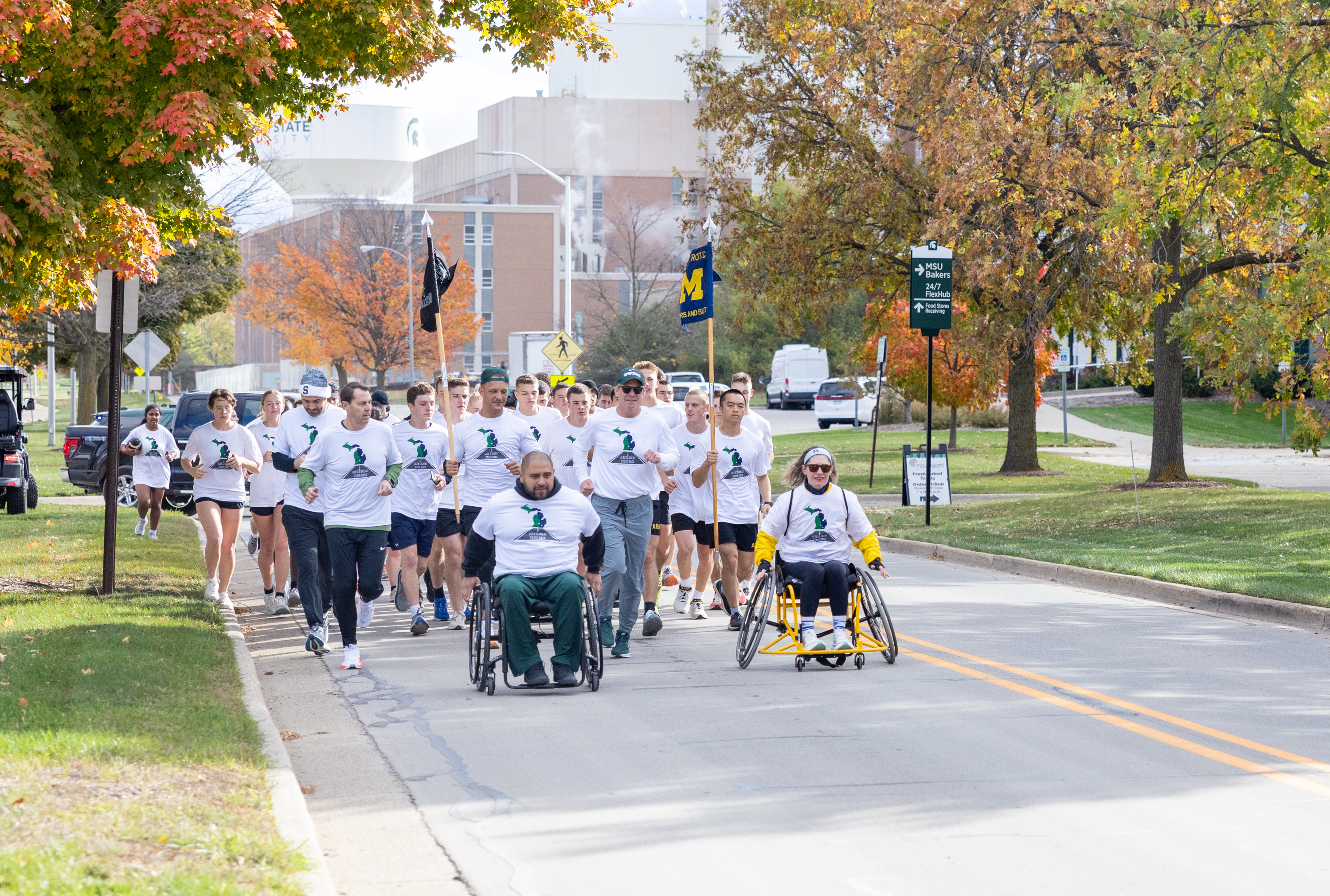 Cadets and adaptive athletes running, rolling in the last mile of the race