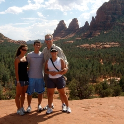 Alex Powell and his family posing for a photo during a vacation together