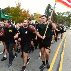 University of Michigan and Michigan State University ROTC members walking Alex's Great State Race