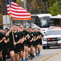 University of Michigan and Michigan State University ROTC members walking Alex's Great State Race