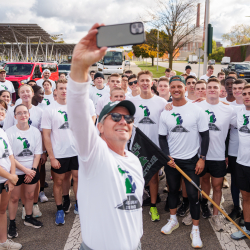 MSU President Guskiewicz taking a selfie with the ROTC at the staging area for the last mile
