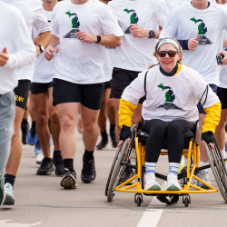 UM Adaptive athlete rolling in the last mile