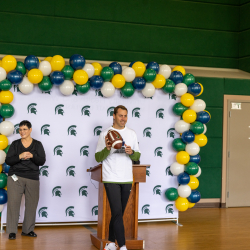 Athletic Director, J. Batt accepting the official game ball during the Landing Ceremony